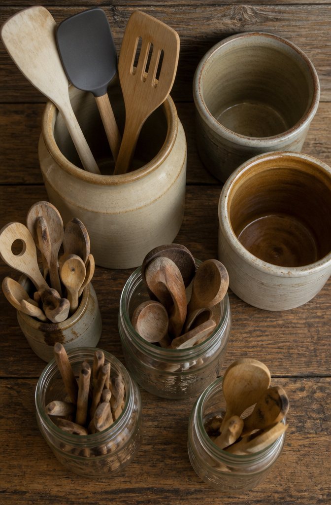 20 Country Style Kitchen Ideas for a Cozy Farmhouse Feel 13 Glass jars and stoneware crocks arranged on kitchen shelves.