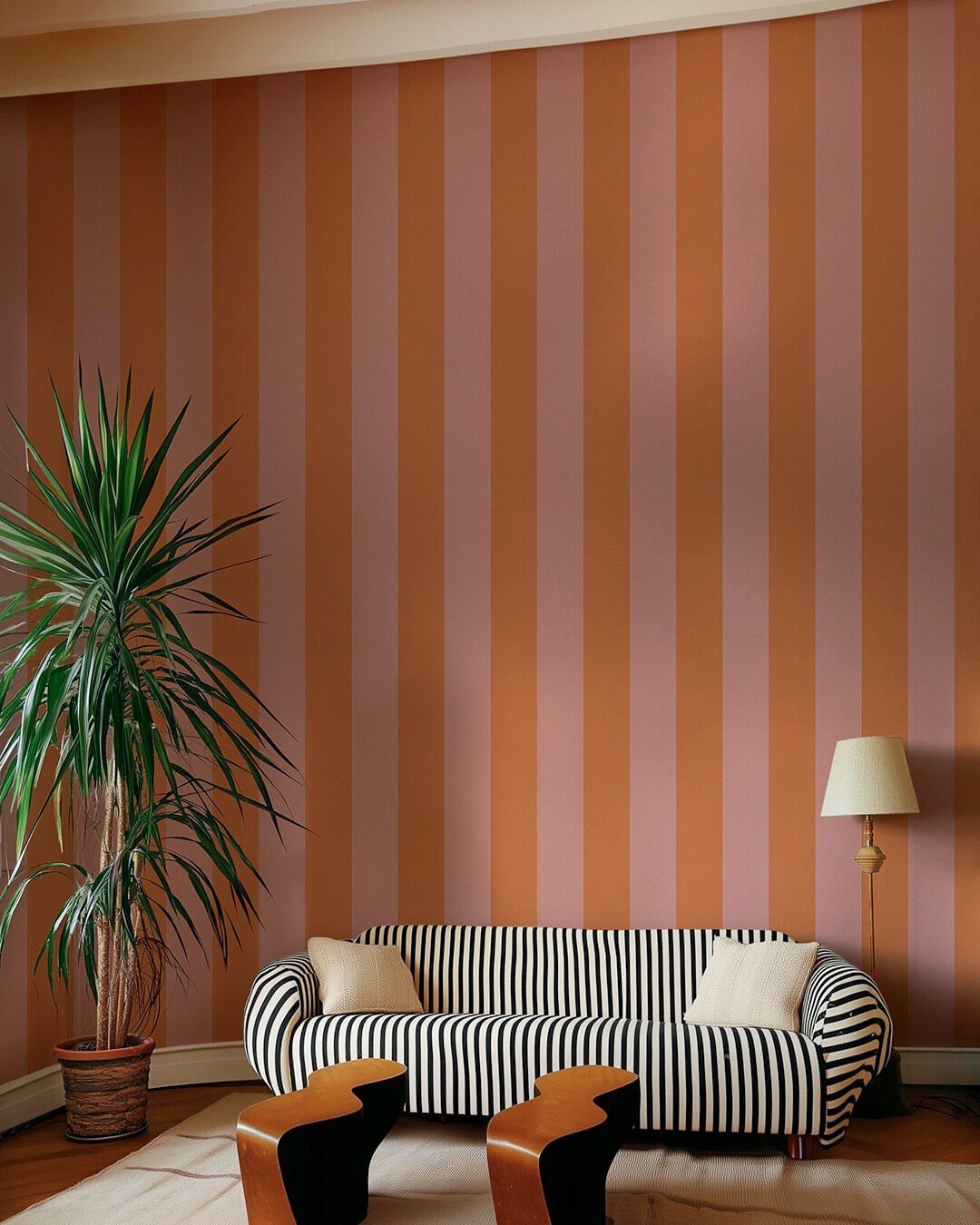 Striped orange and mauve wallpaper in a living room with a striped sofa.