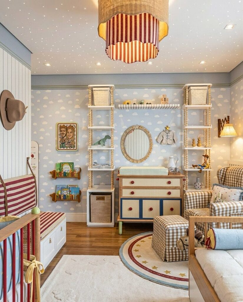 Child's bedroom with cloud wallpaper, striped furniture, and a nautical themed decor.